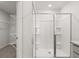New construction shower with glass doors and brushed nickel fixtures at 8223 Coldstream Dr, Fairburn, GA 30213