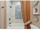 Bathroom showcasing a shower-tub, decorative tiles, and coordinated fixtures at 16 Walker Ne Ter, Atlanta, GA 30309