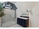 Bathroom with a dark vanity cabinet, frameless glass shower, and decorative mirror for a clean, modern design at 16 Walker Ne Ter, Atlanta, GA 30309