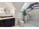Modern bathroom featuring a skylight, glass shower, updated vanity, and stylish fixtures for a spa-like experience at 16 Walker Ne Ter, Atlanta, GA 30309