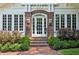 Close up of brick archway front entrance with brick steps, sidelight windows, and manicured landscaping at 16 Walker Ne Ter, Atlanta, GA 30309