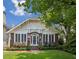Charming brick home with a well-manicured lawn, arched entryway, and large windows at 16 Walker Ne Ter, Atlanta, GA 30309