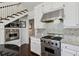 Modern kitchen boasts stainless steel appliances, granite counters, and ample white cabinetry at 16 Walker Ne Ter, Atlanta, GA 30309