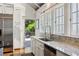 Bright kitchen featuring a stainless steel sink, white cabinets, and an exterior view to the patio at 16 Walker Ne Ter, Atlanta, GA 30309