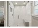 Walk-in shower with white hexagon tiles, glass door, and a built-in shower bench at 16 Walker Ne Ter, Atlanta, GA 30309
