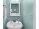 Powder blue bathroom featuring a basin sink with brushed nickel faucet and white decorative mirror at 397 Cypher Dr, Suwanee, GA 30024
