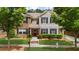 This home features green grass, trimmed bushes, and an American flag at 397 Cypher Dr, Suwanee, GA 30024