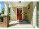 Cozy front porch with a red door, wreath, and space for decorations at 397 Cypher Dr, Suwanee, GA 30024