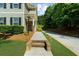 A walkway leads to the front door of this charming home with lush landscaping at 397 Cypher Dr, Suwanee, GA 30024