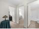 This hallway leads to a neutrally decorated bedroom and bathroom at 397 Cypher Dr, Suwanee, GA 30024