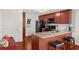 Functional kitchen featuring granite countertops, a breakfast bar, and hardwood floors at 397 Cypher Dr, Suwanee, GA 30024