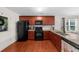 Stylish kitchen with granite countertops, stainless steel appliances, and hardwood floors at 397 Cypher Dr, Suwanee, GA 30024