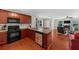 Open kitchen with granite counters, modern appliances, and hardwood floors flowing into the living area at 397 Cypher Dr, Suwanee, GA 30024