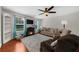 Comfortable living room featuring hardwood floors, a fireplace, and large windows at 397 Cypher Dr, Suwanee, GA 30024