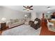 Spacious living room featuring hardwood floors, a ceiling fan, and ample seating at 397 Cypher Dr, Suwanee, GA 30024
