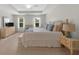 Bright bedroom features a fireplace, tray ceilings, and two large windows at 397 Cypher Dr, Suwanee, GA 30024