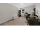 This is a carpeted office with lots of shelves for storage and a comfy office chair at 397 Cypher Dr, Suwanee, GA 30024