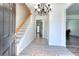 Inviting entryway with hardwood floors, a staircase, and an elegant chandelier at 630 Beckenham Walk Dr, Dacula, GA 30019