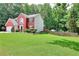 Beautiful home with a large lawn, complemented by mature trees offering ample shade at 630 Beckenham Walk Dr, Dacula, GA 30019