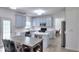 Eat-in kitchen featuring grey cabinets, stainless steel appliances, and an island at 630 Beckenham Walk Dr, Dacula, GA 30019