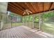 A screened back porch area with plenty of space and wooded views at 6516 Maddox Rd, Morrow, GA 30260