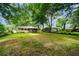 Expansive backyard with lush greenery and mature trees, providing ample space and privacy at 6516 Maddox Rd, Morrow, GA 30260