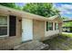 Charming single-story home featuring a brick facade, white door and black shutters and inviting curb appeal at 6516 Maddox Rd, Morrow, GA 30260