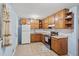 This eat-in kitchen offers tile floors, wooden cabinets and stainless steel appliances at 6516 Maddox Rd, Morrow, GA 30260