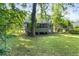 View of the house from the large backyard with mature trees at 752 Jefferson Sw Ave, Atlanta, GA 30315