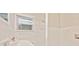 This bathroom features white tile, a window, and a single sink at 752 Jefferson Sw Ave, Atlanta, GA 30315