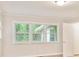 A sunny bedroom features light walls, trim, floors, and a window at 752 Jefferson Sw Ave, Atlanta, GA 30315