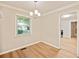 Cozy dining room with hardwood floors, modern chandelier, and easy access to the kitchen at 752 Jefferson Sw Ave, Atlanta, GA 30315