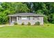 Charming gray brick home featuring a lush green lawn and manicured landscaping at 752 Jefferson Sw Ave, Atlanta, GA 30315