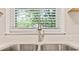Close-up of a stainless steel kitchen sink with a modern faucet and natural light streaming in at 752 Jefferson Sw Ave, Atlanta, GA 30315