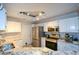 Bright kitchen featuring white cabinets, stainless steel appliances, and granite countertops at 1315 Mcgill Park Ne Ave, Atlanta, GA 30312