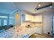 Eat-in kitchen offers bright white cabinets, granite counters, stainless steel sink, and eat-in bar at 1315 Mcgill Park Ne Ave, Atlanta, GA 30312