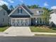 Charming craftsman-style home with a well-manicured lawn and a two-car garage at 1534 Bedstone Dr, Canton, GA 30114