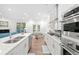 Bright kitchen with stainless steel appliances that is open to the living room at 1534 Bedstone Dr, Canton, GA 30114