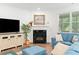 Cozy living room with a fireplace and large screen television at 1534 Bedstone Dr, Canton, GA 30114