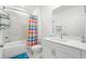 Bathroom with tile walls and floors plus a shower with a striped shower curtain at 1534 Bedstone Dr, Canton, GA 30114