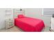 Bedroom with gray nightstand and shelf hanging above a bed with a red blanket at 1534 Bedstone Dr, Canton, GA 30114