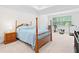 Bedroom features a bed, wood nightstand, and natural light coming in from the window at 1534 Bedstone Dr, Canton, GA 30114
