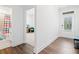 Hallway with hardwood floors leading to a bathroom and a room with a view to the outside at 1534 Bedstone Dr, Canton, GA 30114