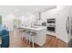 Bright kitchen features a large island with bar stool seating, stainless steel appliances, and sleek white cabinets at 1534 Bedstone Dr, Canton, GA 30114