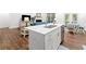 Modern kitchen featuring a central island, stainless steel appliances, and a seamless connection to the living area at 1534 Bedstone Dr, Canton, GA 30114