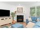 Inviting living room with a fireplace, hardwood floors, and a cozy seating area at 1534 Bedstone Dr, Canton, GA 30114