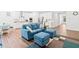Bright living room with hardwood floors, comfortable blue seating, and an open flow into the kitchen at 1534 Bedstone Dr, Canton, GA 30114