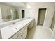 Bathroom with granite countertops, double sinks, and framed mirrors at 2314 Shetley Creek Dr, Norcross, GA 30071