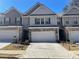 Charming townhome featuring a two-car garage and landscaped front yard at 2314 Shetley Creek Dr, Norcross, GA 30071