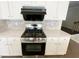 Close-up of a stainless steel gas range with overhead vent at 2314 Shetley Creek Dr, Norcross, GA 30071
